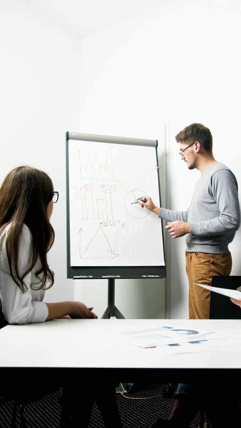 A businessperson giving a presentation with charts in a modern office environment.