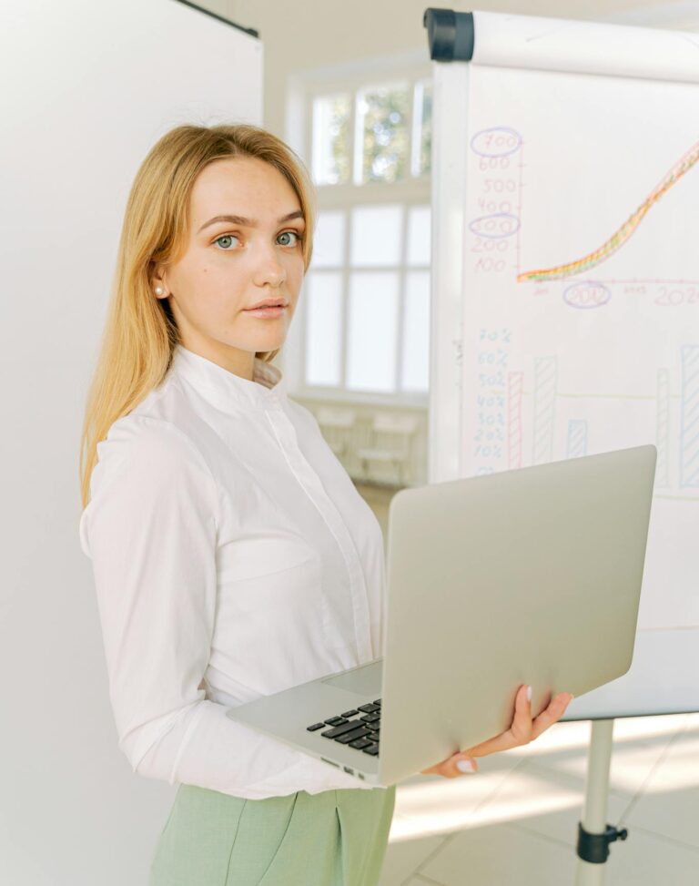 Confident businesswoman presenting data in a bright office setting.
